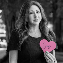 Life-Assist employee holding a Project Pink heart honoring a loved one lost to breast cancer